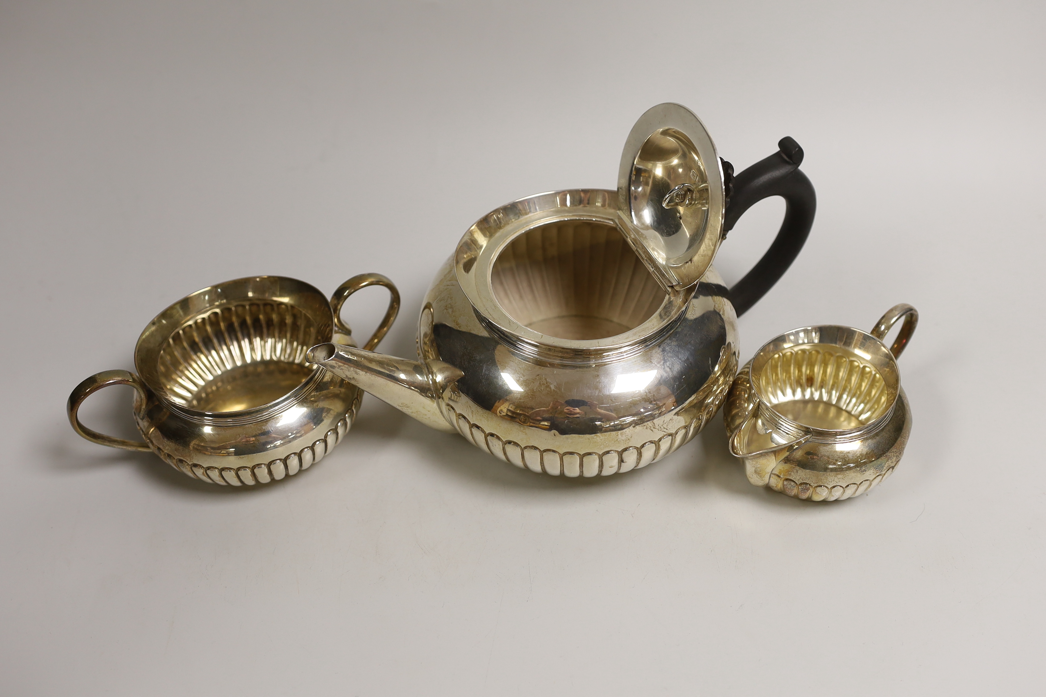 A late Victorian demi-fluted silver three piece tea set, Hukin & Heath, London, 1893/4/5, gross weight 27.6oz.